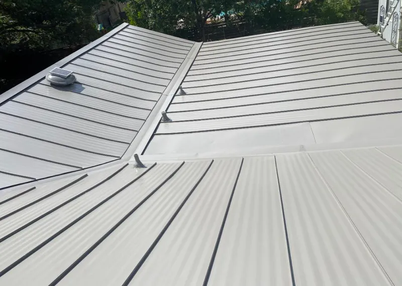 Solar attic fan installed on a metal roof for Roof Ventilation in Powder Springs